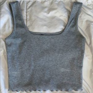 Grey crop top with frilly edge along the bottom